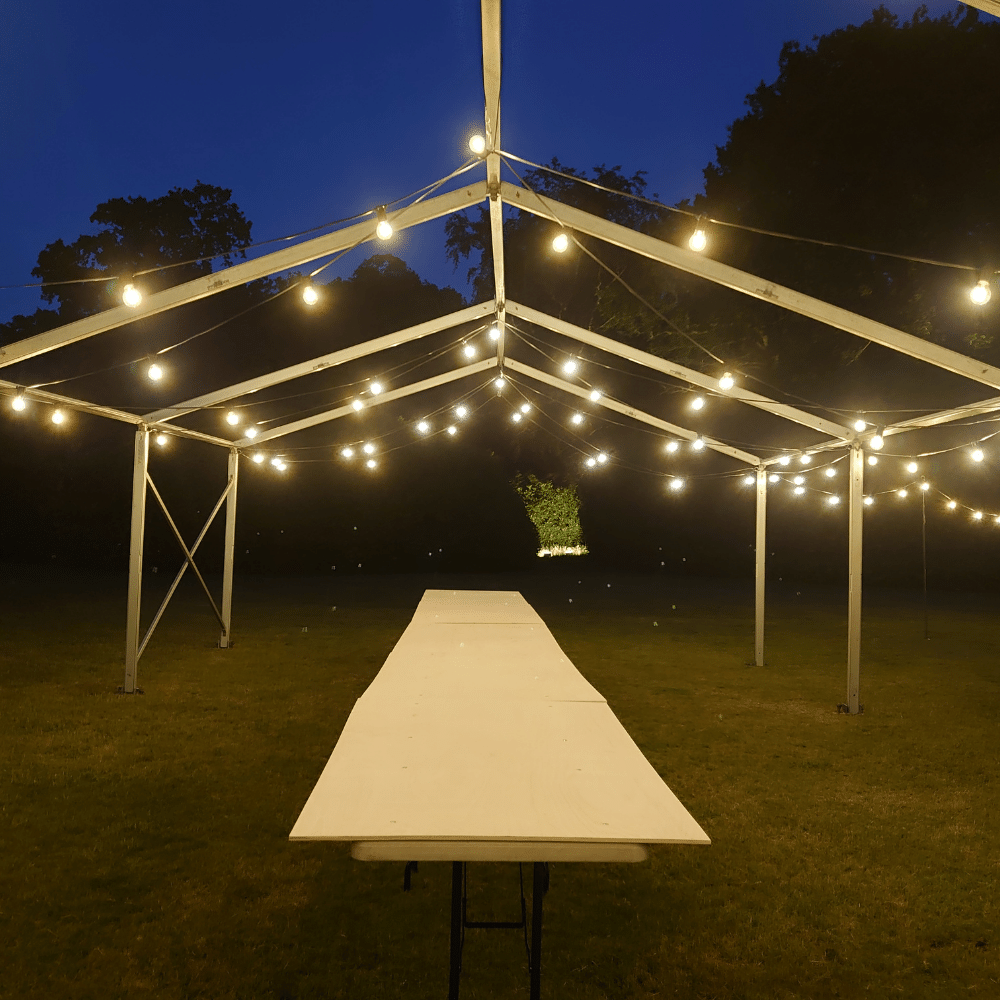 Outdoor festoon lighting at an event marquee